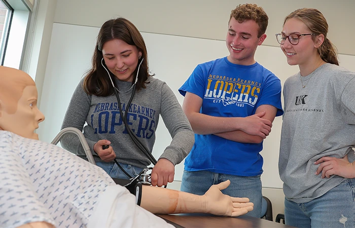 image of students practicing with a medical dummy