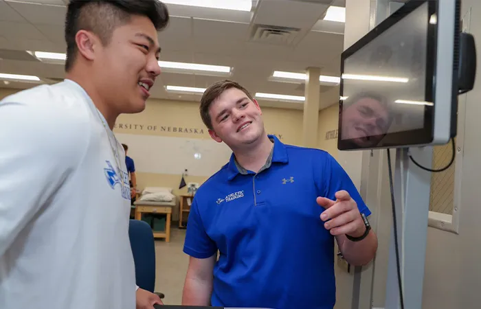 an athletic training student works with a patient