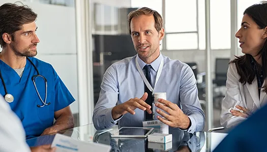 a man in a meeting speaks with doctors