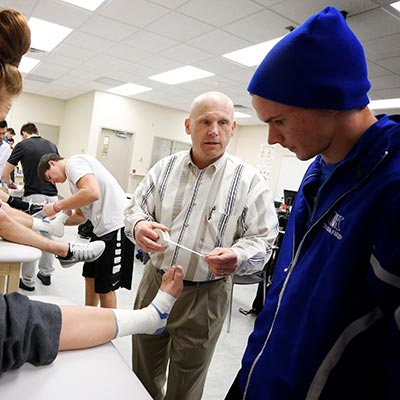 a faculty member and student treat a patient at a clinic