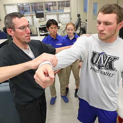 Athletic trainer working with students