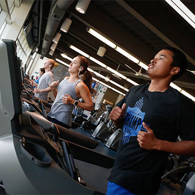 students running on treadmills in the wellness center