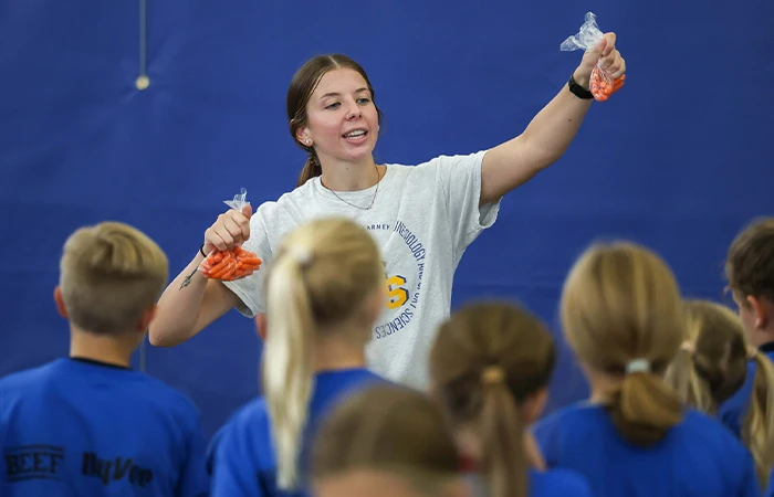 an instructor with students in a gym