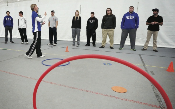 Teacher and students in a gym