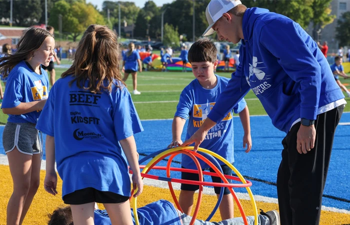 image of student playing tug of war with kids during fitness day