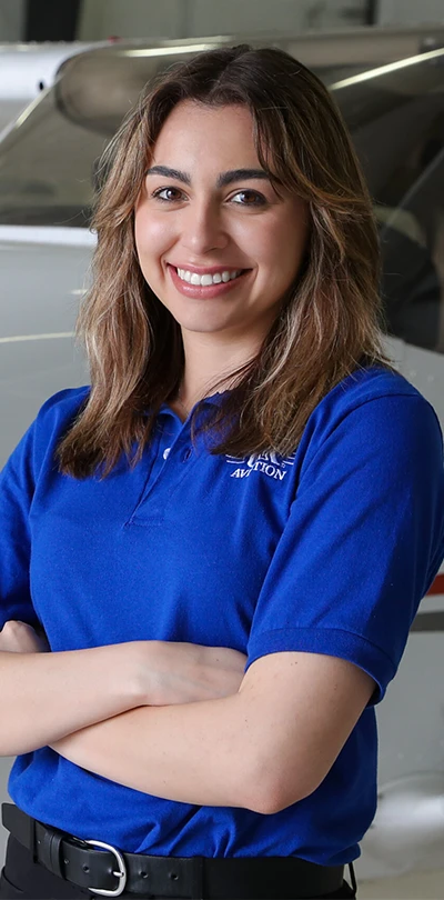 a student stands in front of an aircraft