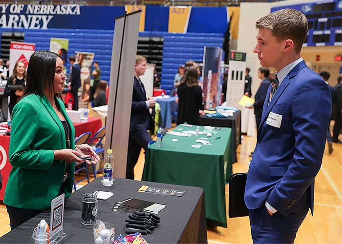 a unk student speaks with an employer at a career fair
