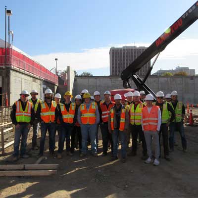 construction management students pose for a picture on a job site tour