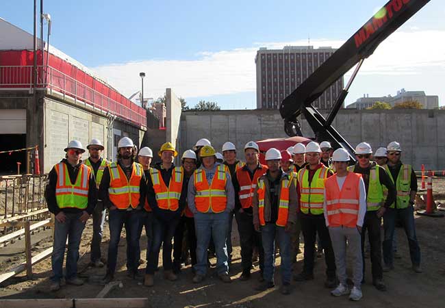 Construction Management students pose for a group photo at a construction site