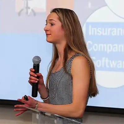 a student holds a microphone
