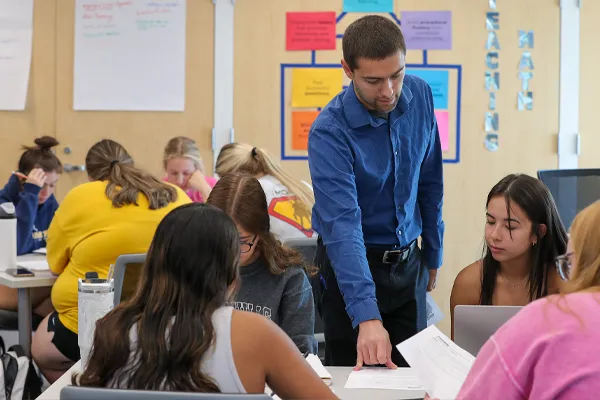 a math professor works with students