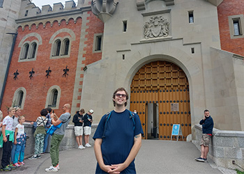 a student on a study abroad trip stands in front of a church