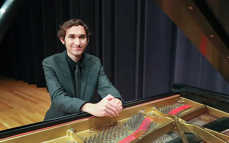 UNK music student sitting at a piano