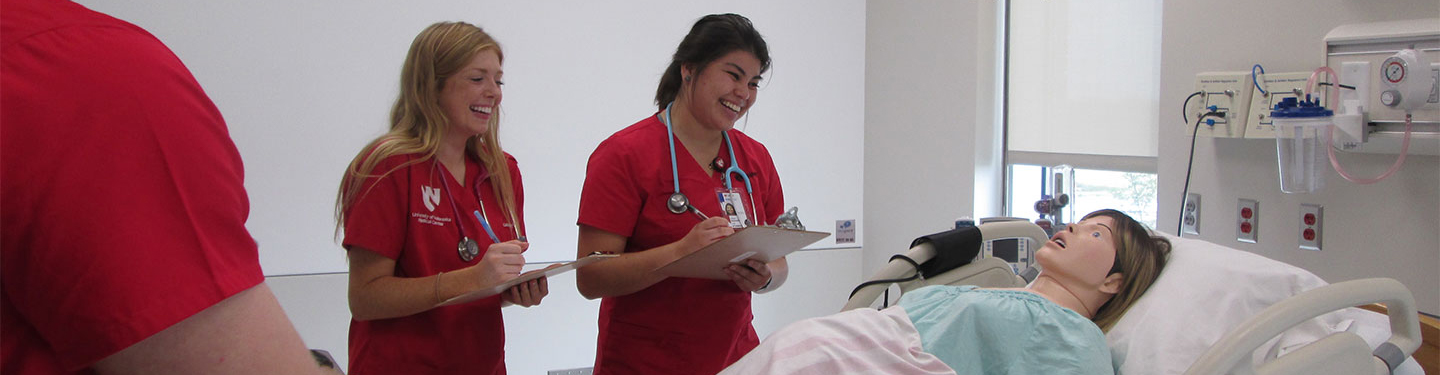 Nursing students practicing with a health doll