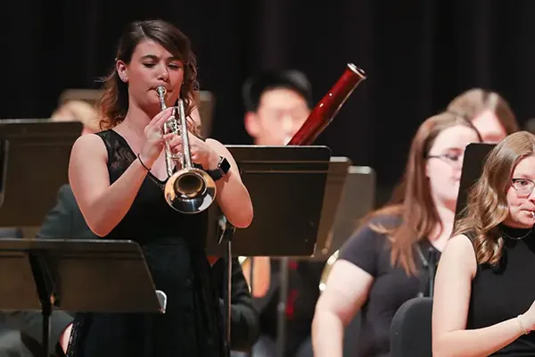 a student performs in an orchestra