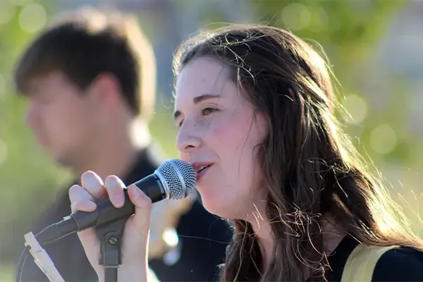 a student sings into a microphone