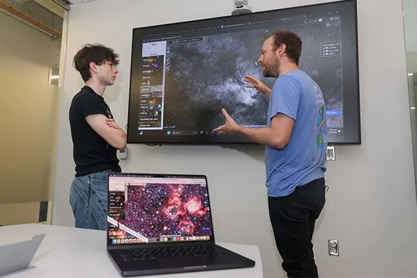 a student and professor work with star charts