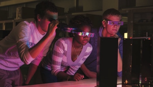 Physics students performing experiment