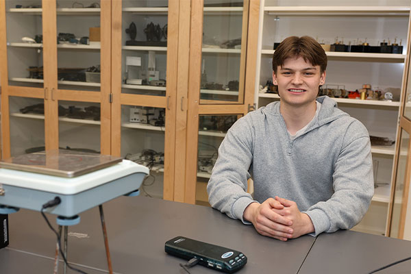 a student poses for a photo in a science lab