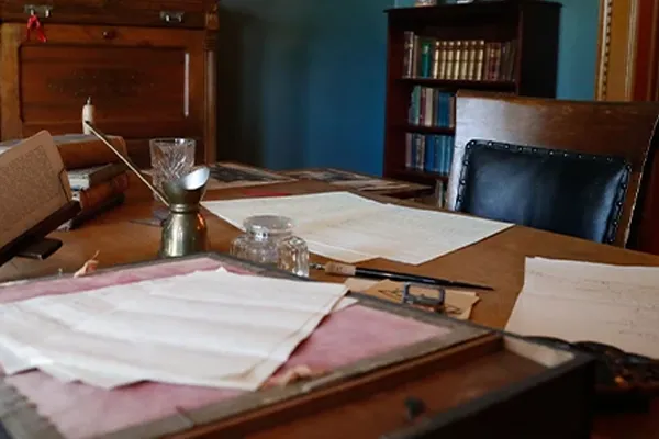 a desk in a museum littered with artifacts