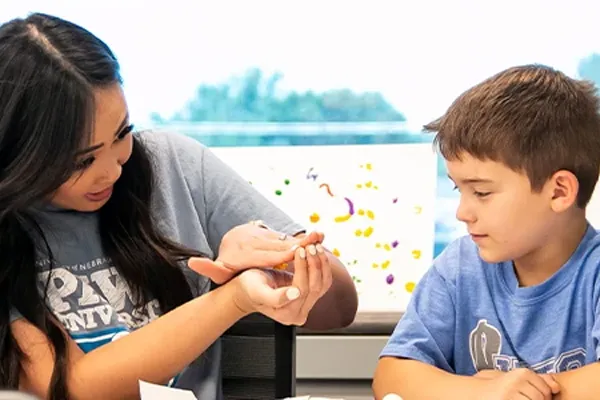 a Speech-language pathologists works with a child