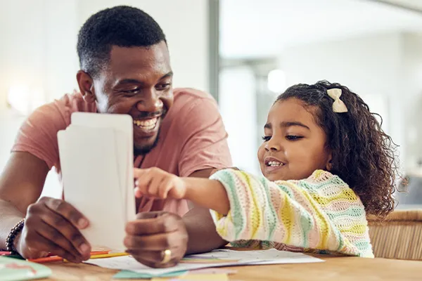 a man and child work with flash cards