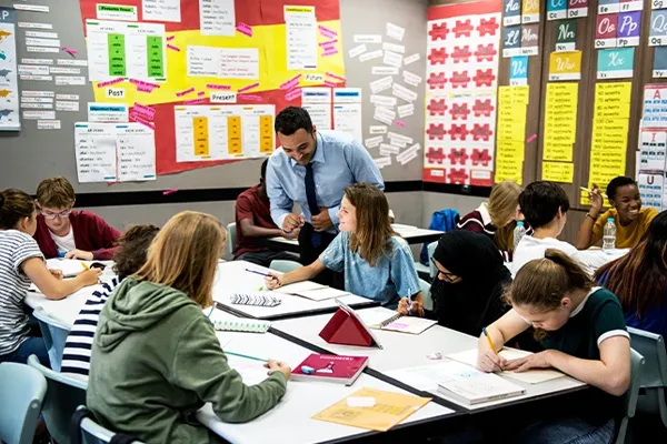a teacher works with students in a classroom