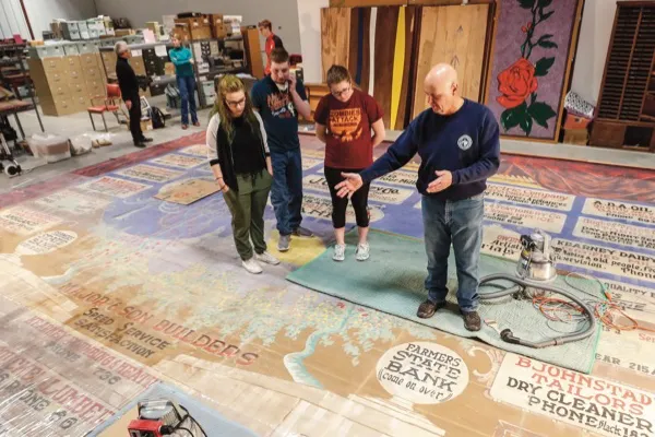 a teacher instructs student during a restoration project