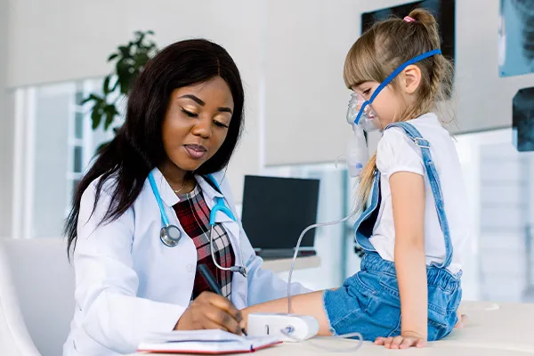 a respiratory therapist works with a patient