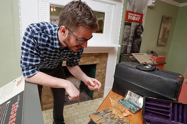 a professor showcases a museum exhibit