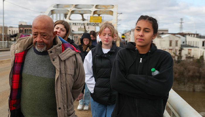 Civil rights activist Charles Mauldin, left, and UNK sophomore Jamie Vaughn lead a group of political science students across Edmund Pettus Bridge in Selma, Alabama