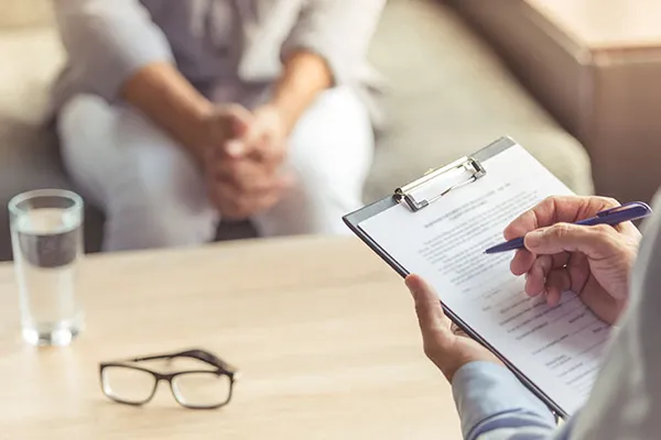 stock image of a person writing on a clipboard