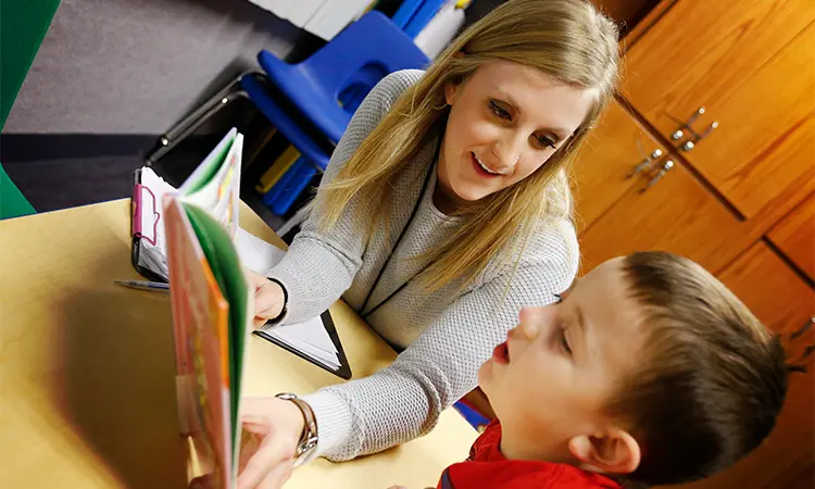 teacher helps a student