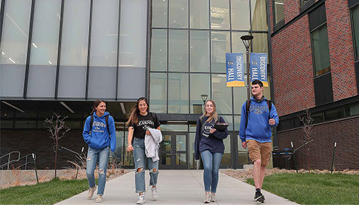 students walk together outside discovery hall