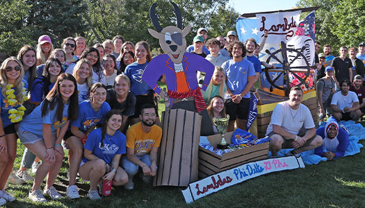 greek life students gather around a homecoming float