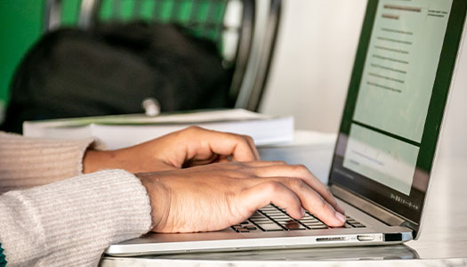 a student types on a laptop