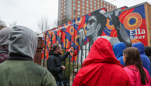 students and instructors view a mural on their visit to atlanta