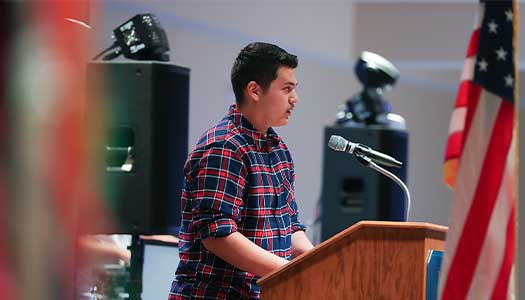 a student speaks at the Hispanic heritage month celebration