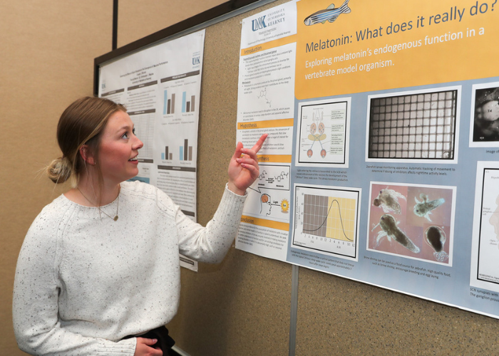 Student presenting poster at graduate research day