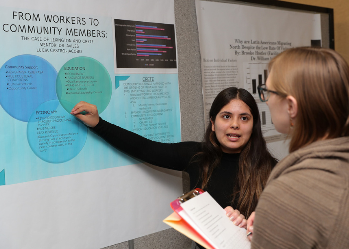 Student presenting poster at graduate research day