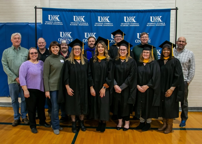 Group photo of UNK's Biology M.S. graduates and Biology faculty and staff at UNK's commencement ceremony.