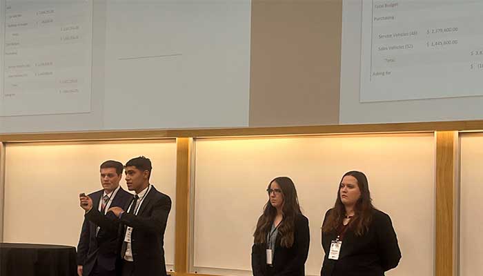 UNK students giving the presentation at UNL for the Business Competition