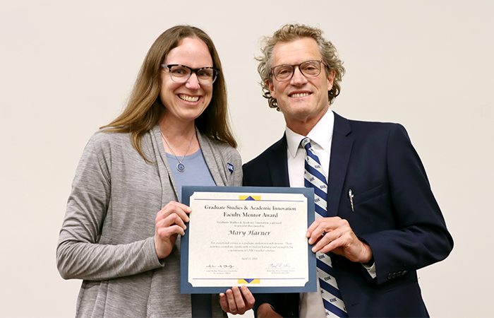 Communications professor, Dr. Mary Harner receiving the Graduate Studies & Academic Innovation Faculty Mentor Award from Dean of Graduate Studies Dr. Mark Ellis.