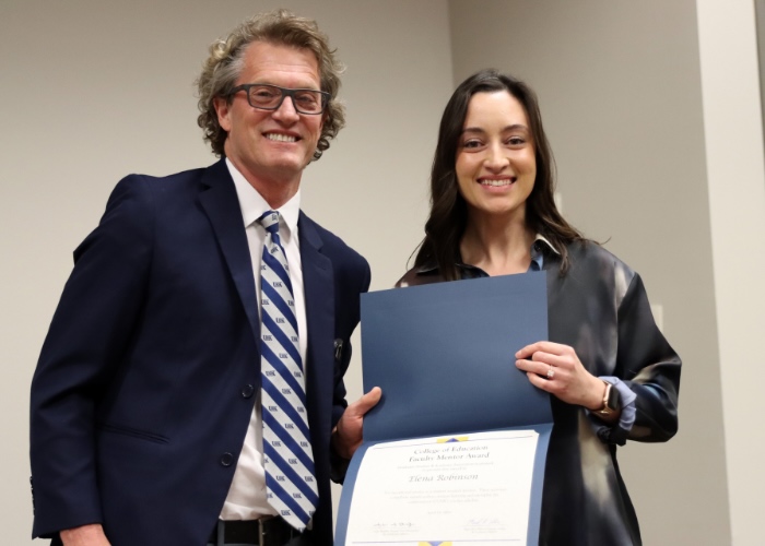 Man presenting woman with an award.