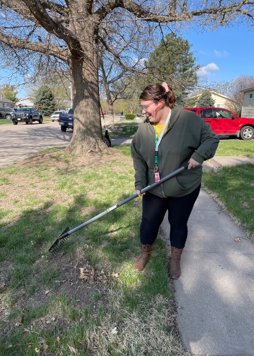 Woman raking yard.