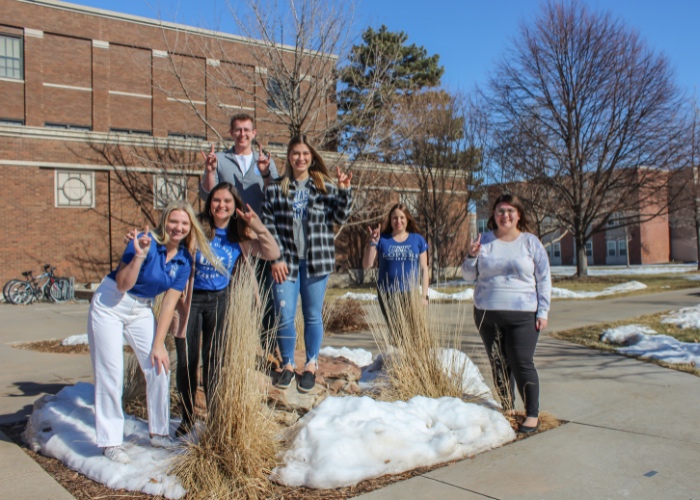 Six students posing for photo on campus