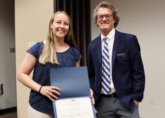 Man presenting a woman award.