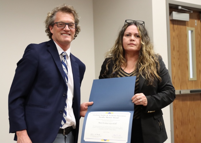 A man presenting a woman an award.