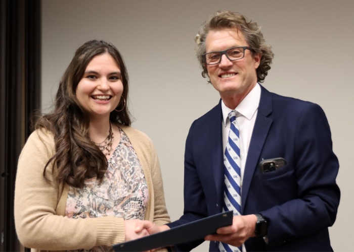 Man presenting woman with an award.