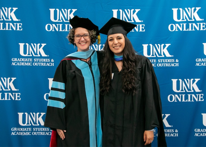 Two women in graduation attire.